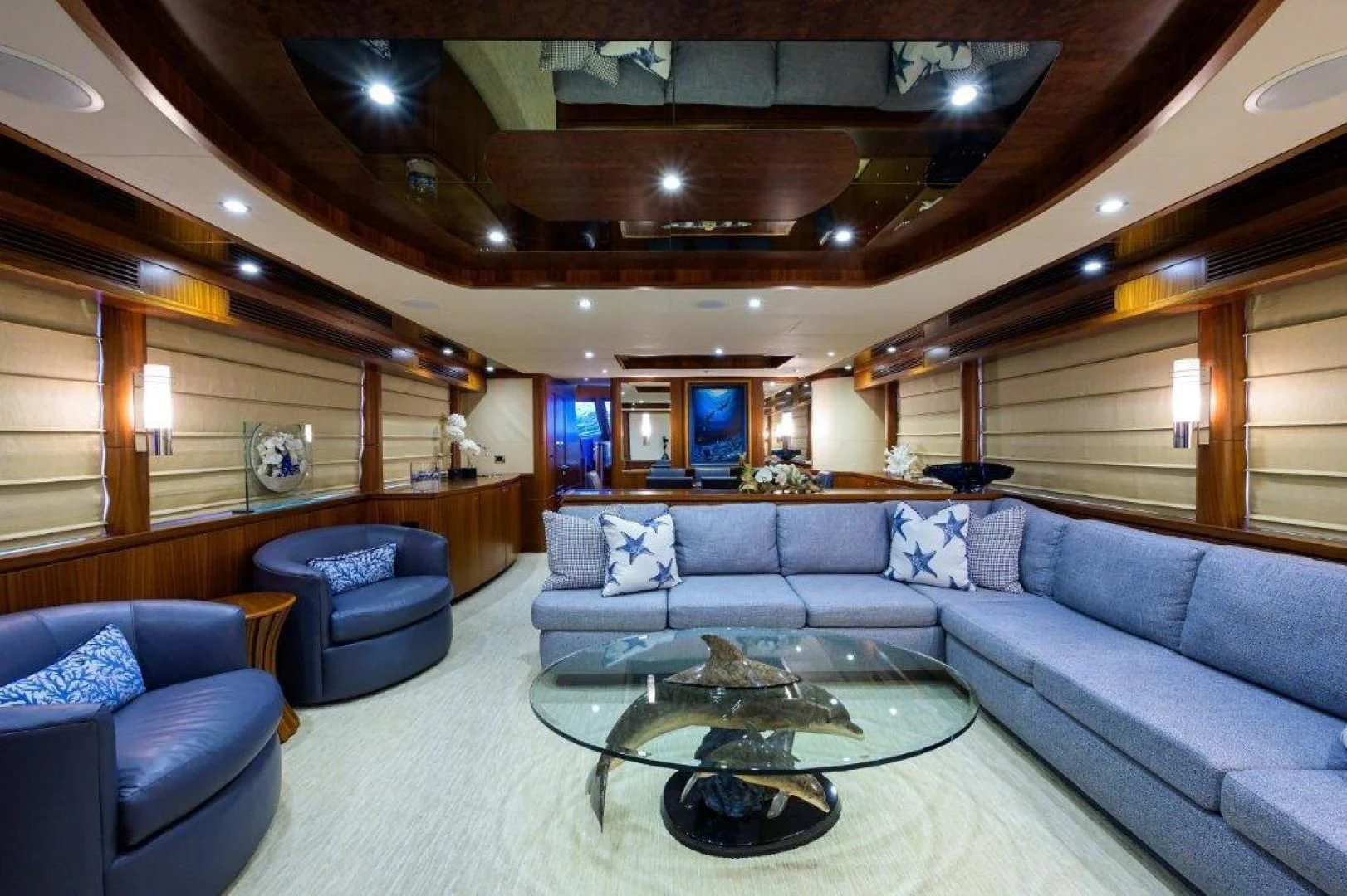a living room with a large glass table and a large window aboard SOUNDINGS Yacht for Sale