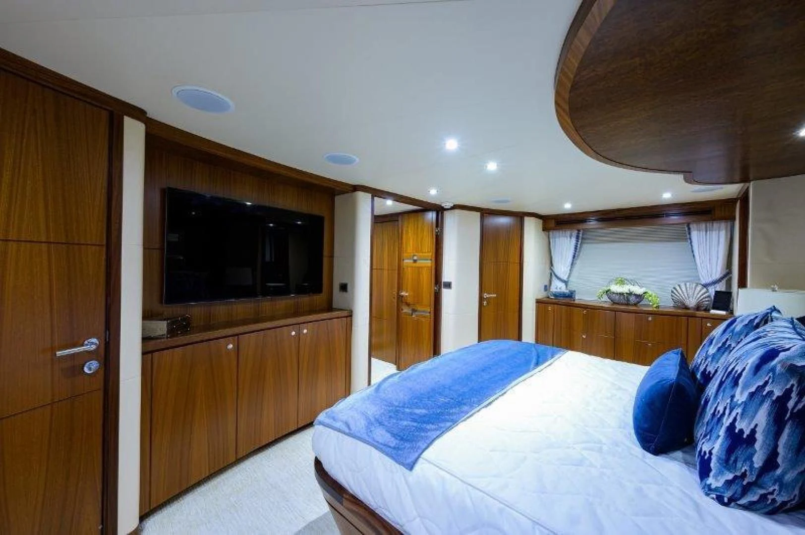 a bedroom with a bed and a television aboard SOUNDINGS Yacht for Sale
