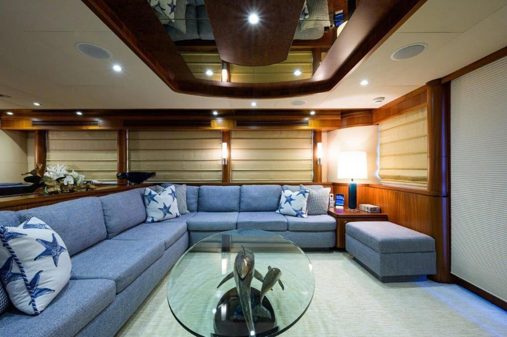a living room with a blue couch aboard SOUNDINGS Yacht for Sale