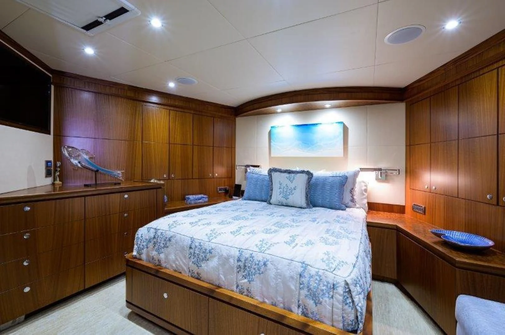 a bedroom with wood cabinets aboard SOUNDINGS Yacht for Sale