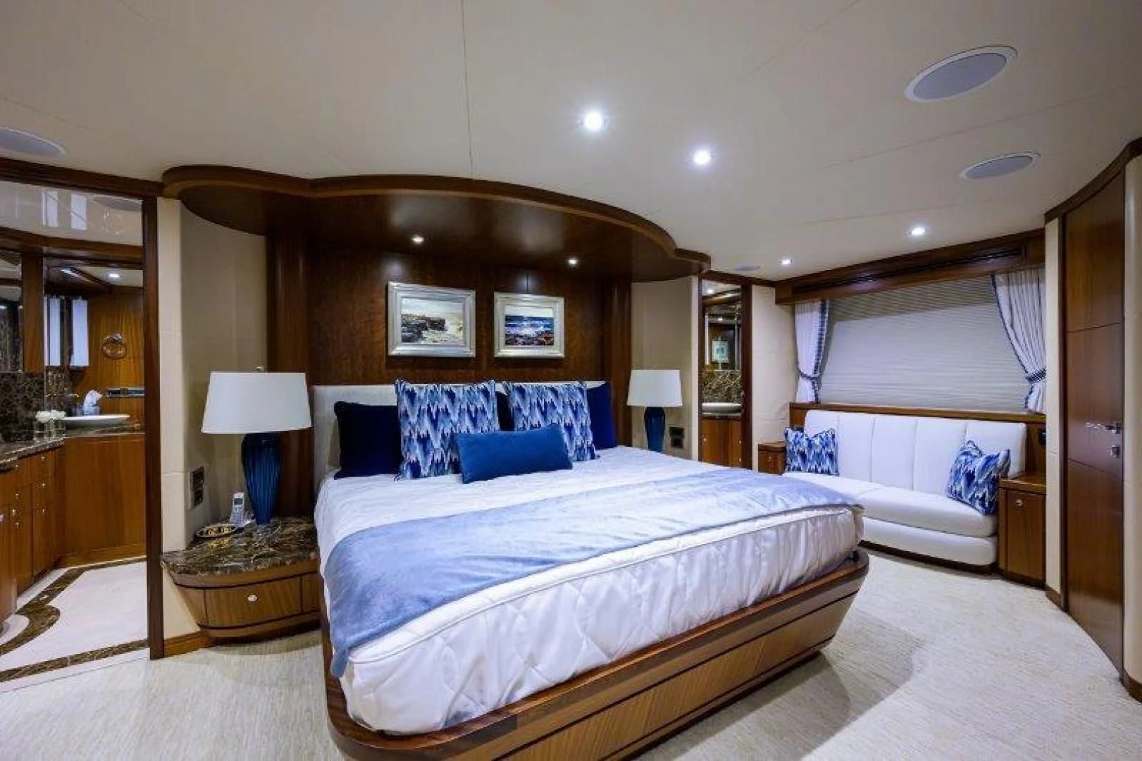a bedroom with a bed and a lamp aboard SOUNDINGS Yacht for Sale