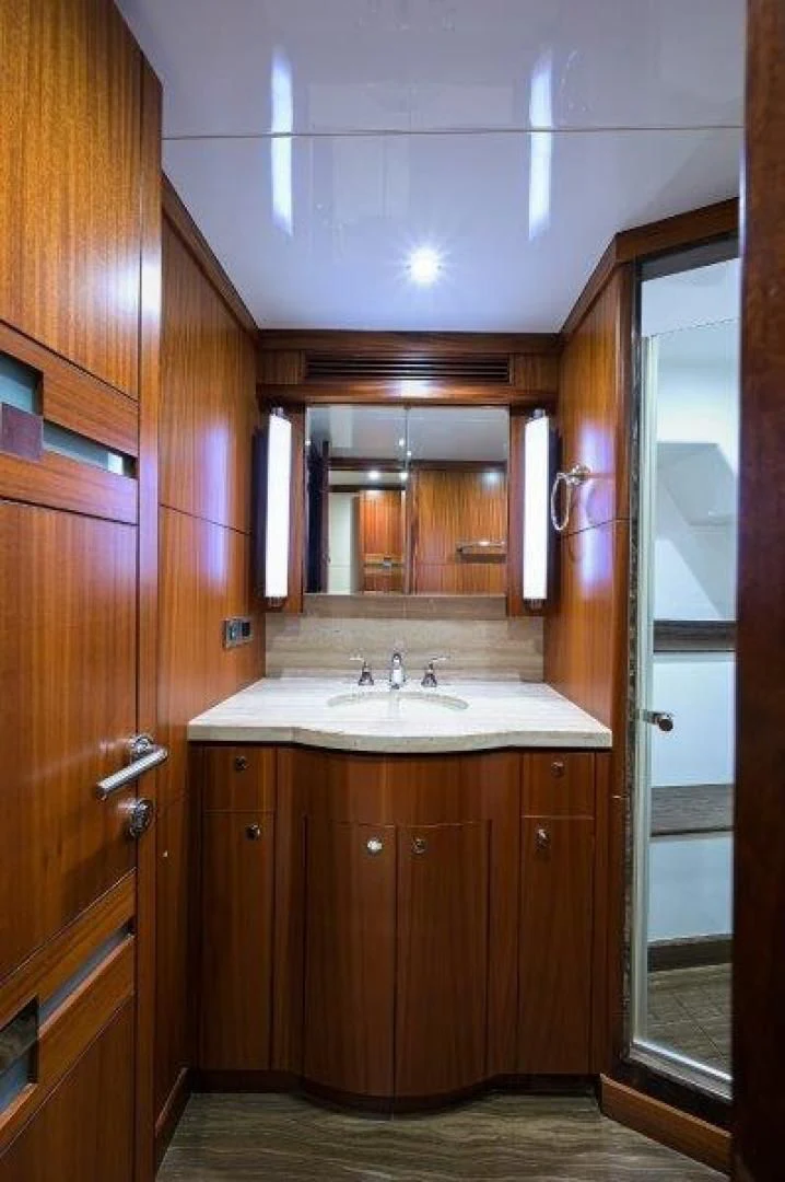 a bathroom with wooden cabinets aboard SOUNDINGS Yacht for Sale