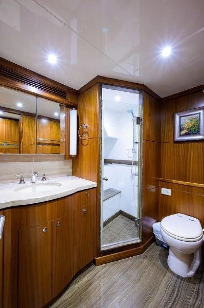 a bathroom with a glass shower door aboard SOUNDINGS Yacht for Sale