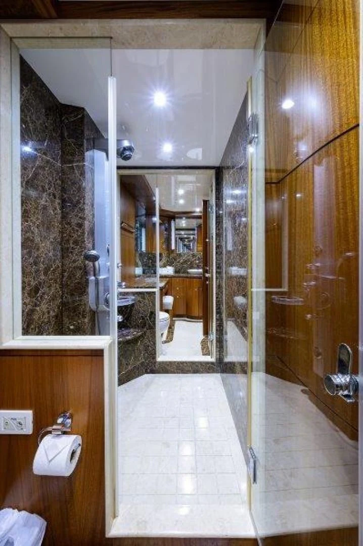 a bathroom with a glass shower aboard SOUNDINGS Yacht for Sale
