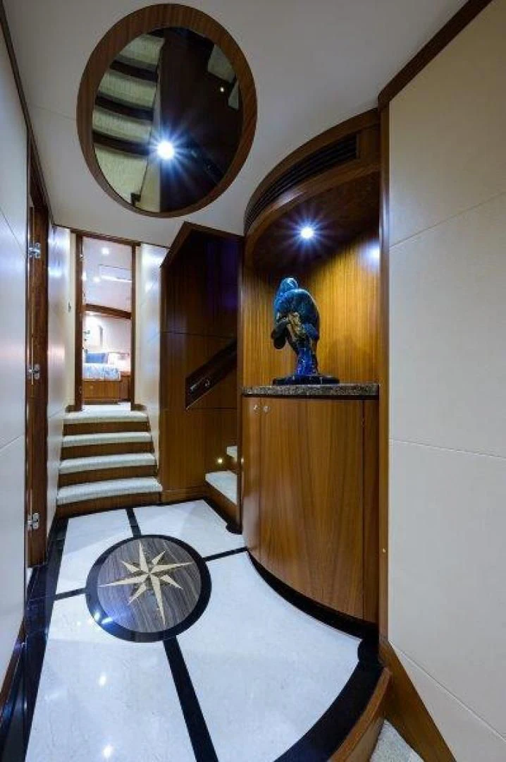 a large mirror hangs over a staircase aboard SOUNDINGS Yacht for Sale