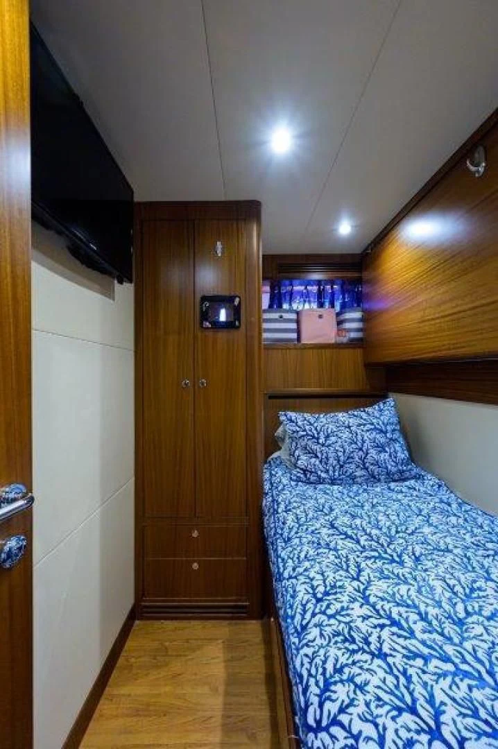 a bedroom with a wood door aboard SOUNDINGS Yacht for Sale