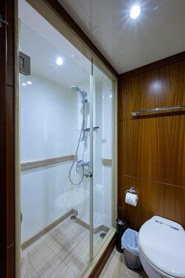 a bathroom with a shower and toilet aboard SOUNDINGS Yacht for Sale