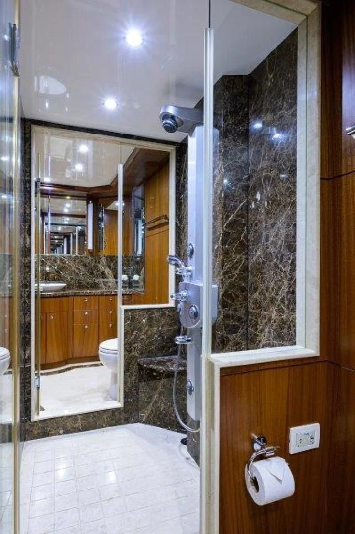 a bathroom with a glass shower aboard SOUNDINGS Yacht for Sale