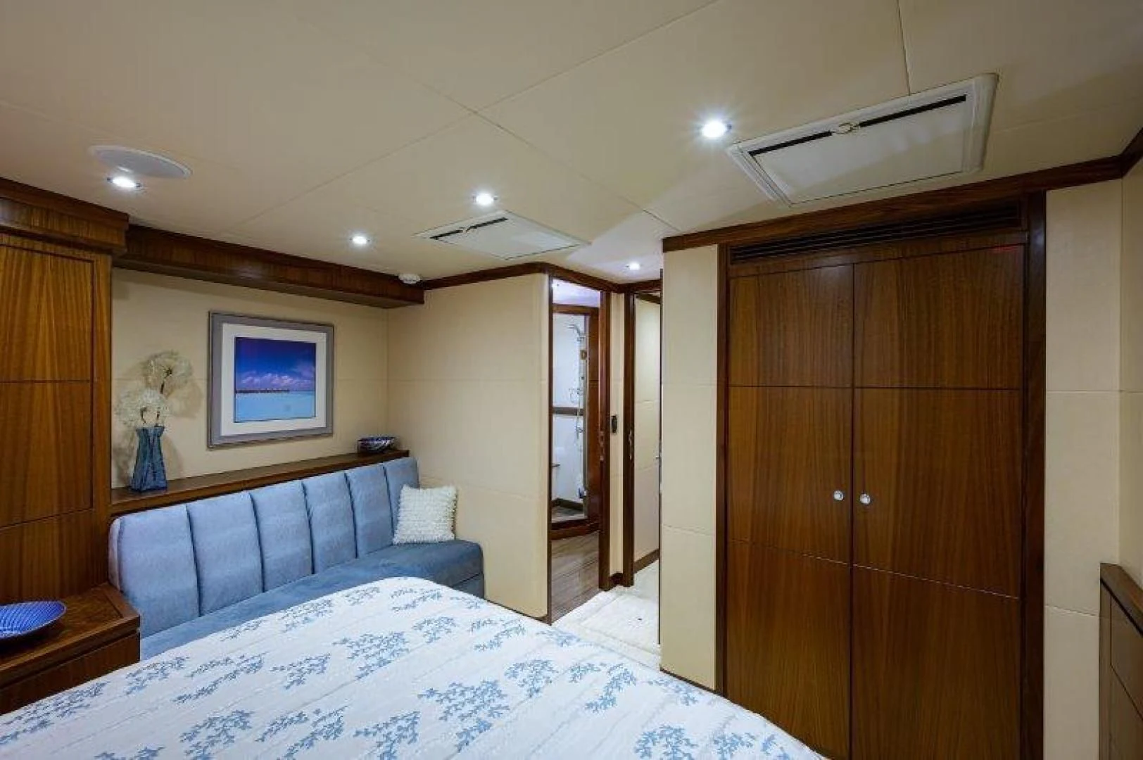 a bedroom with a bed and a wood cabinet aboard SOUNDINGS Yacht for Sale