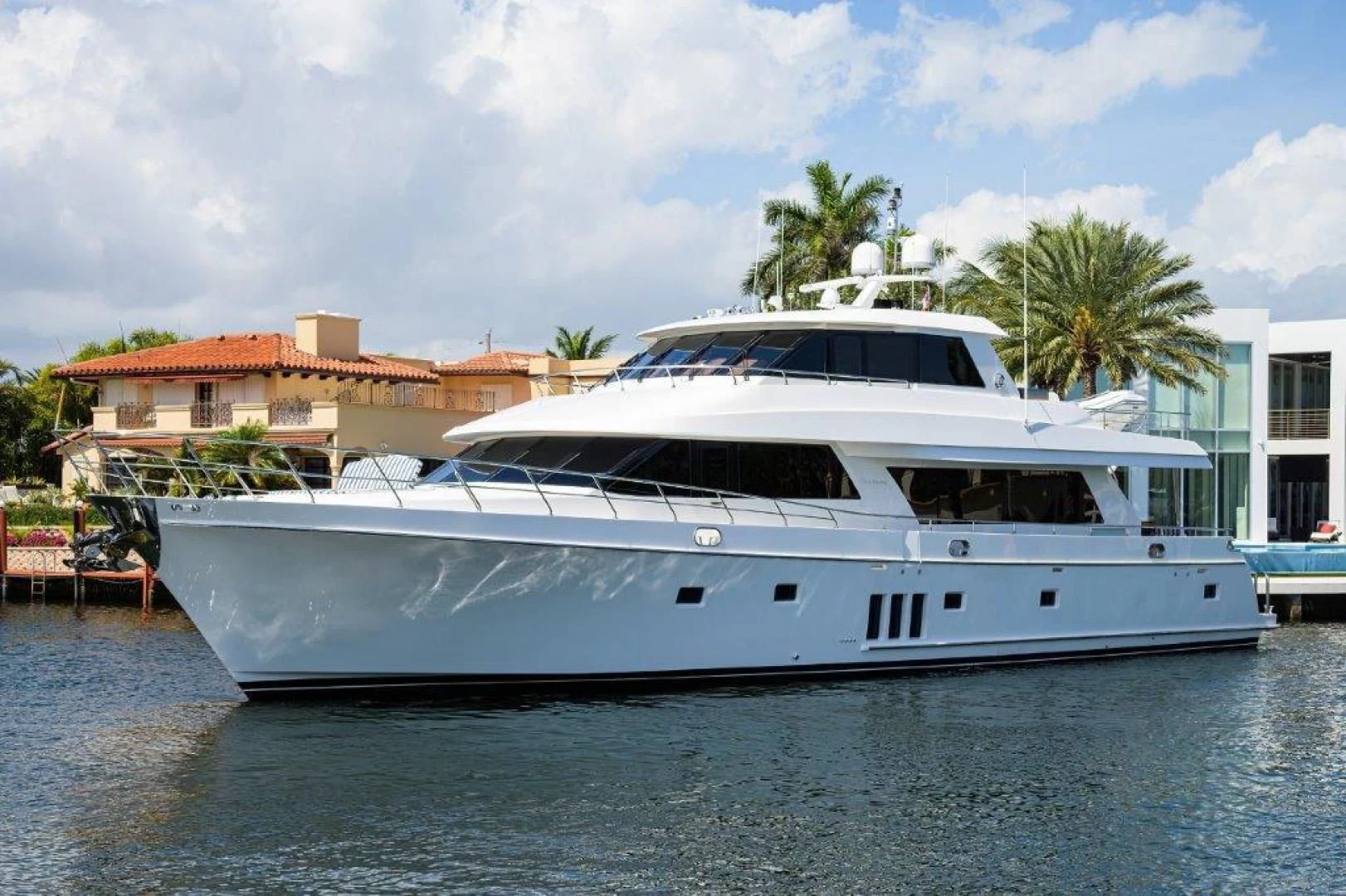 a white yacht in a harbor aboard SOUNDINGS Yacht for Sale