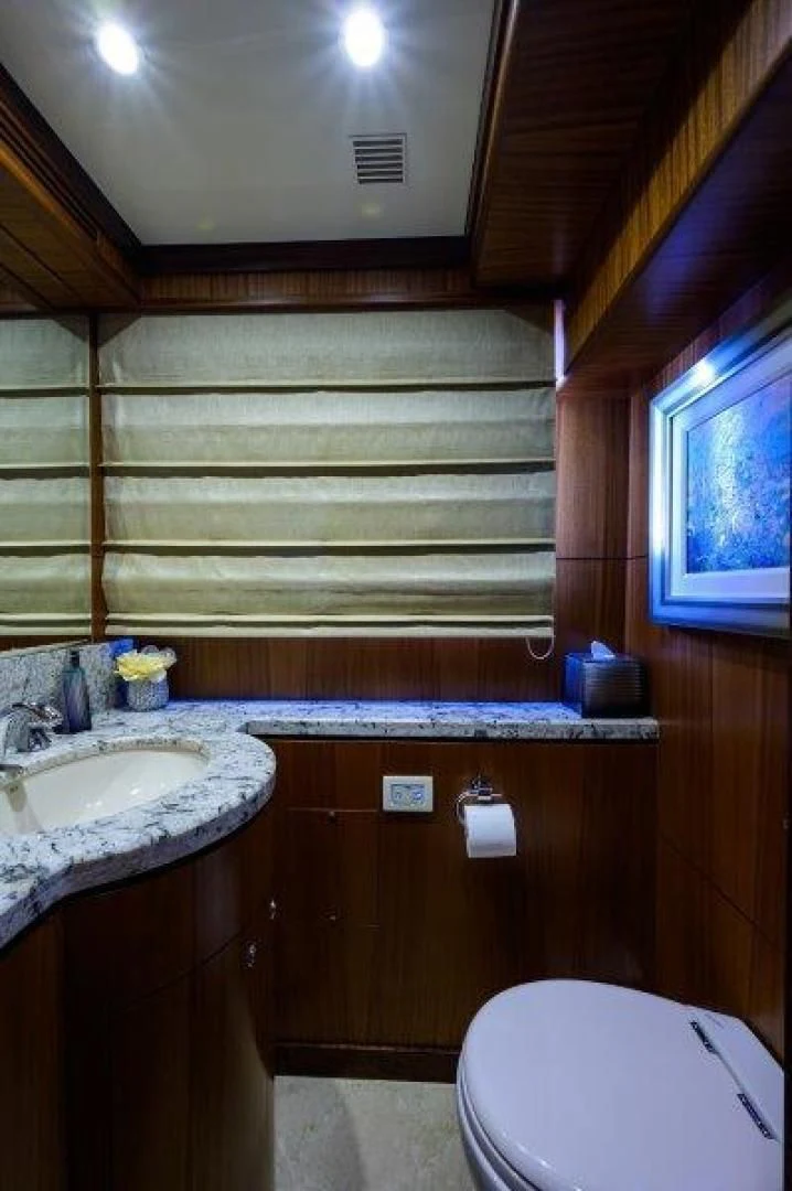 a bathroom with a wood paneled wall aboard SOUNDINGS Yacht for Sale