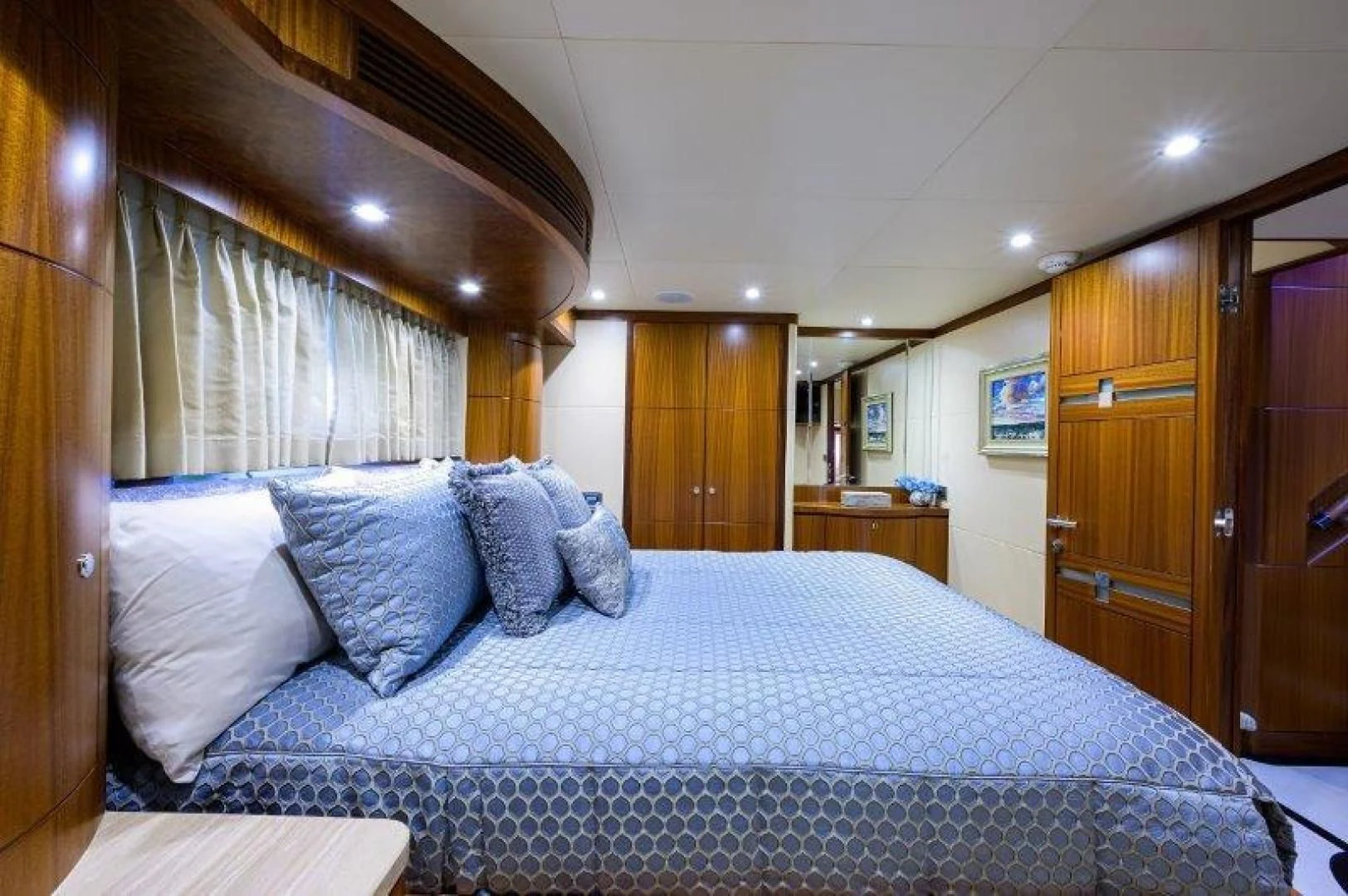 a bed with blue and white sheets aboard SOUNDINGS Yacht for Sale