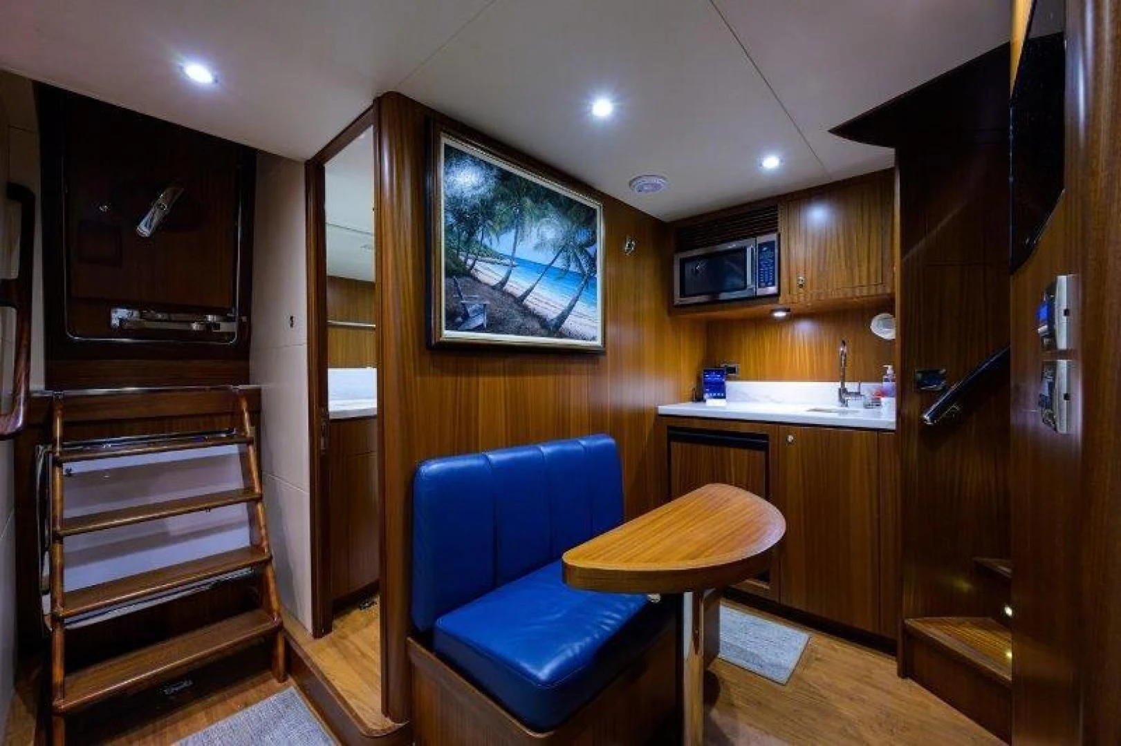 a living room with a blue chair aboard SOUNDINGS Yacht for Sale