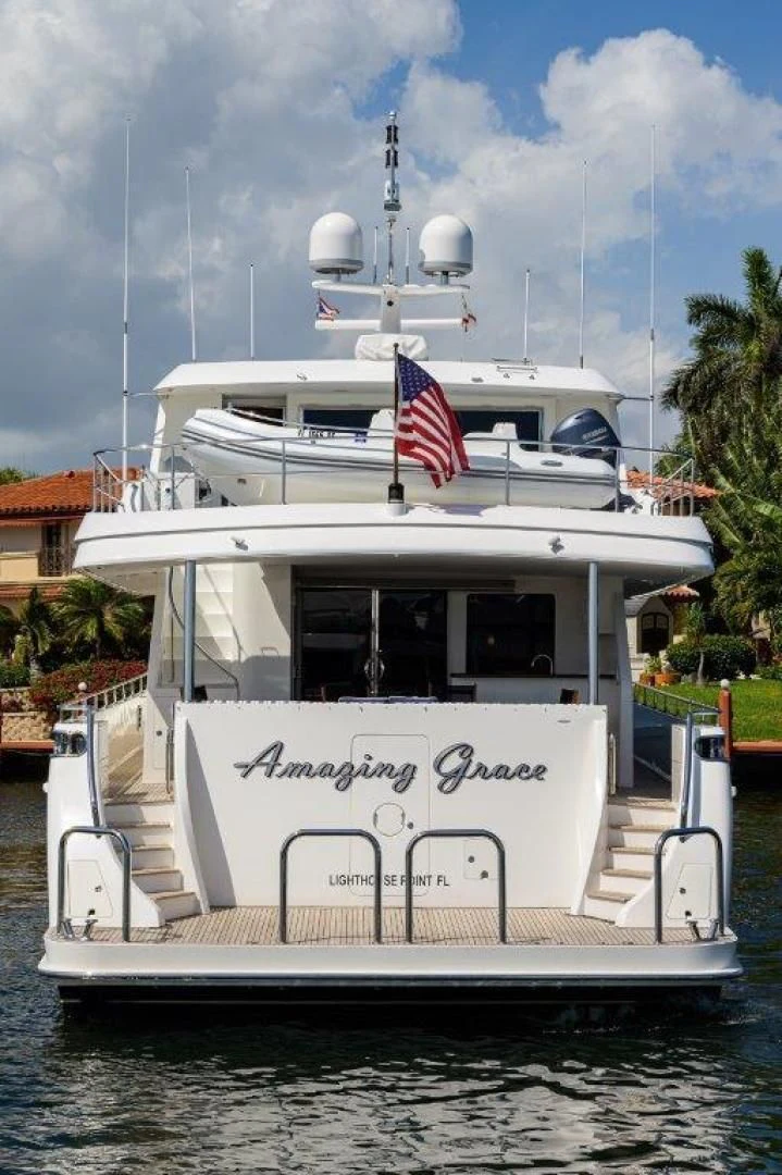 a boat with a flag on the front aboard SOUNDINGS Yacht for Sale
