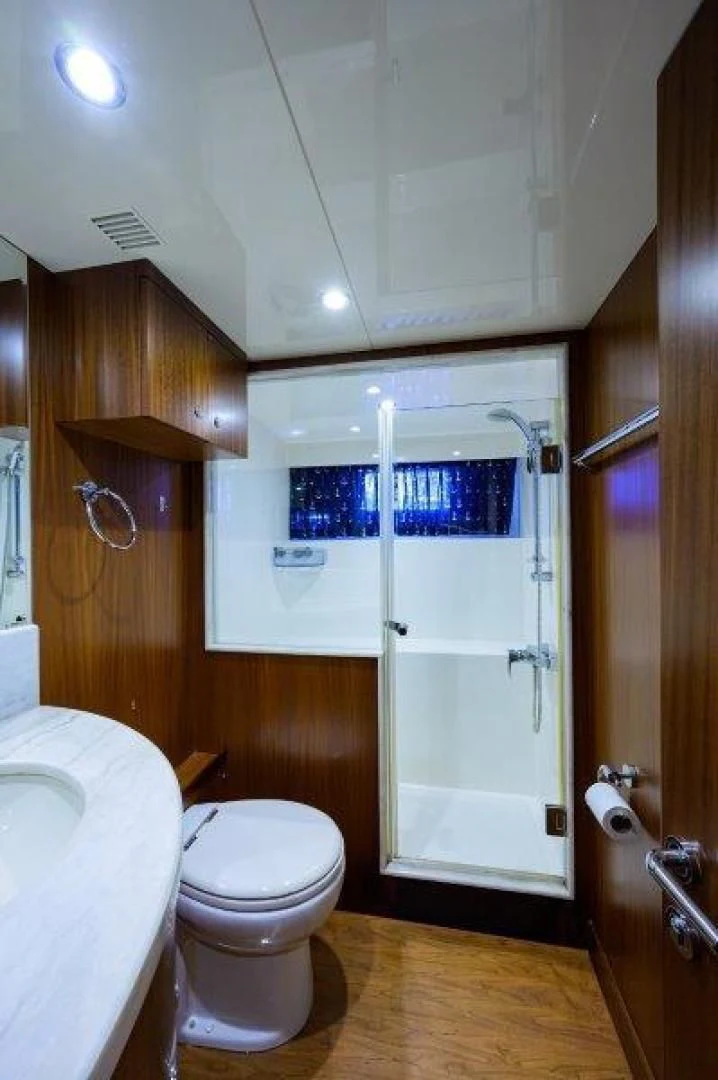 a bathroom with a toilet and sink aboard SOUNDINGS Yacht for Sale