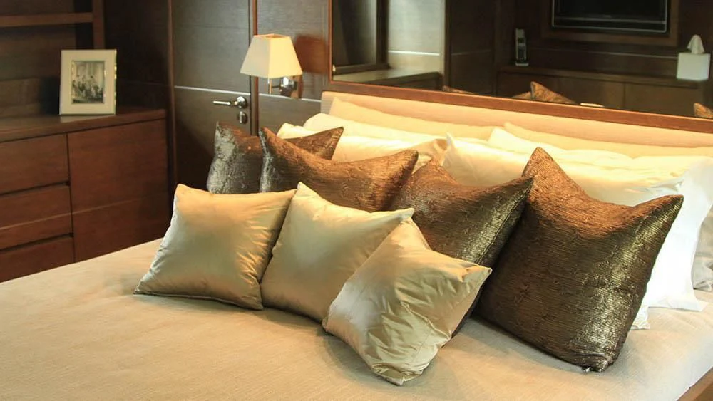 a bed with pillows aboard MYSVEN Yacht for Sale