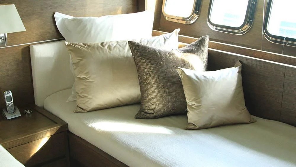 a cat sitting on a bed aboard MYSVEN Yacht for Sale