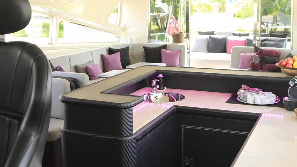 a living room with a purple couch aboard MYSVEN Yacht for Sale
