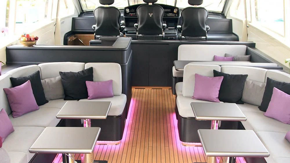 a room with a couch and a table with chairs aboard MYSVEN Yacht for Sale