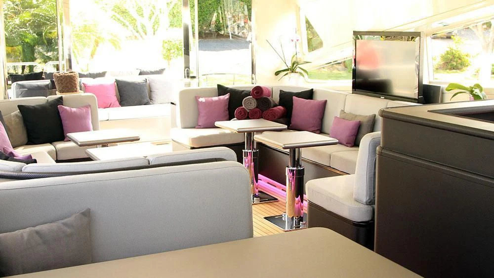 a living room with a couch and a table aboard MYSVEN Yacht for Sale