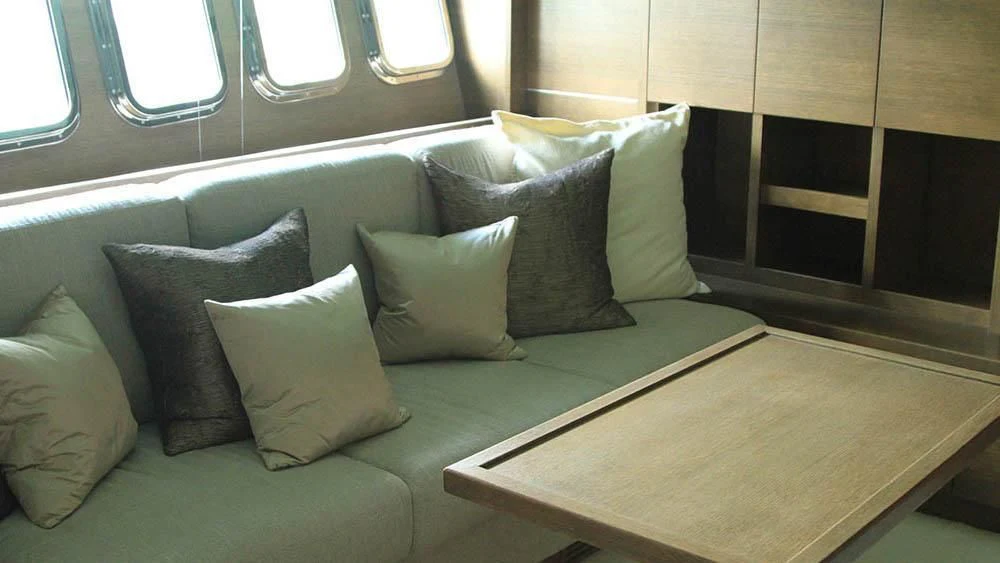 a couch with pillows on it aboard MYSVEN Yacht for Sale