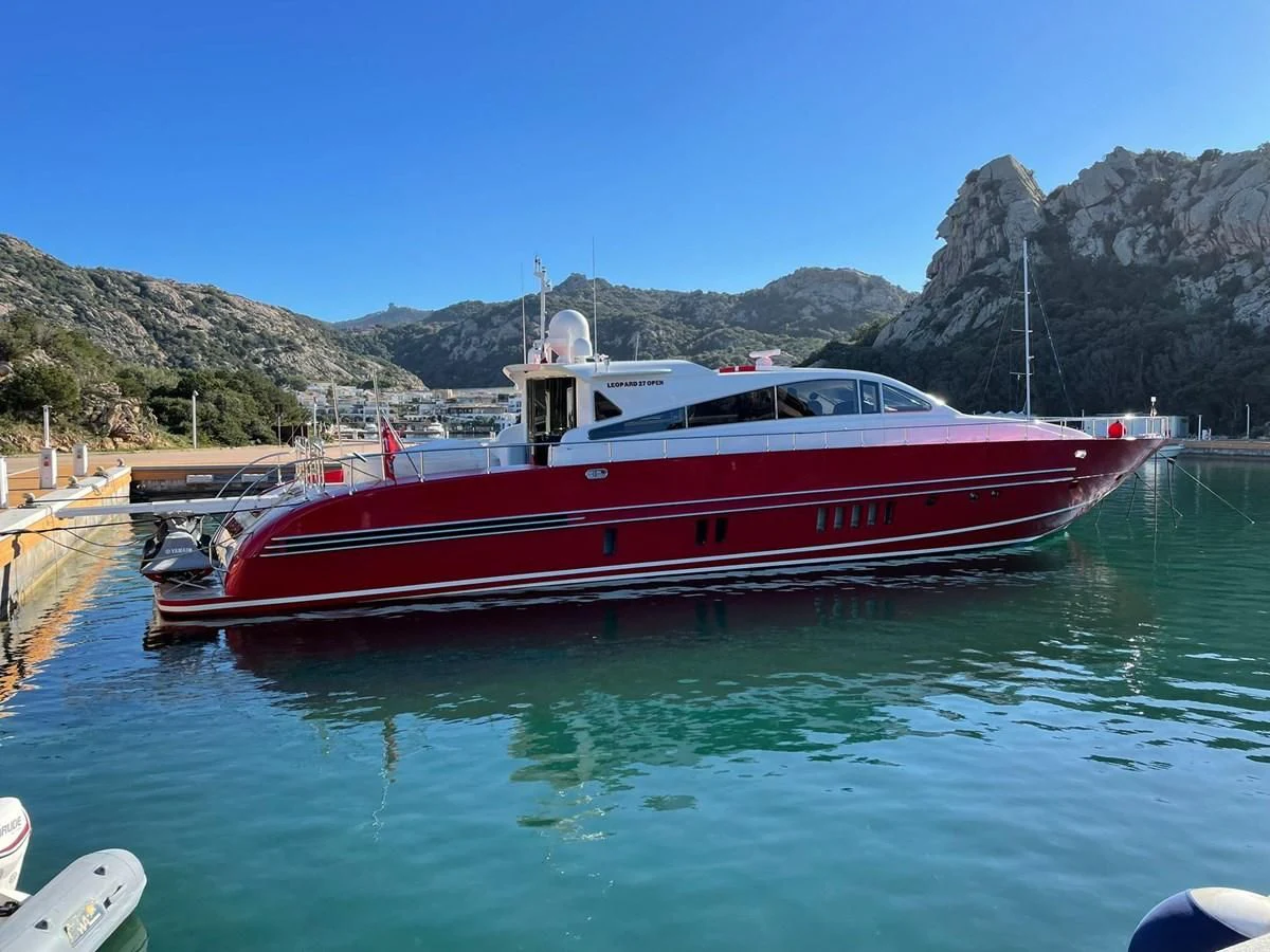 a red and white boat in a lake aboard MYSVEN Yacht for Sale