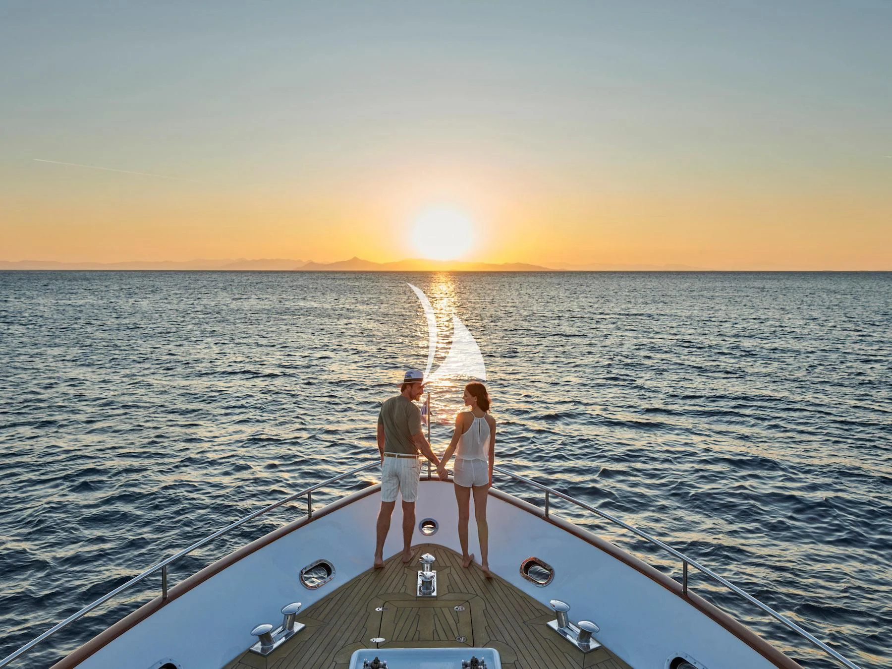 a group of people standing on a boat in the water aboard MIA ZOI Yacht for Charter