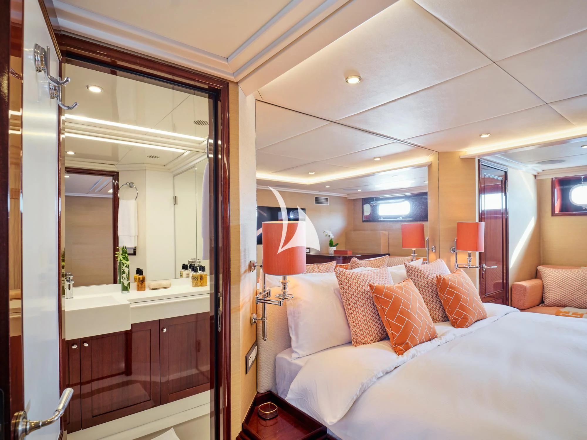 a room with a bed and a mirror aboard MIA ZOI Yacht for Charter