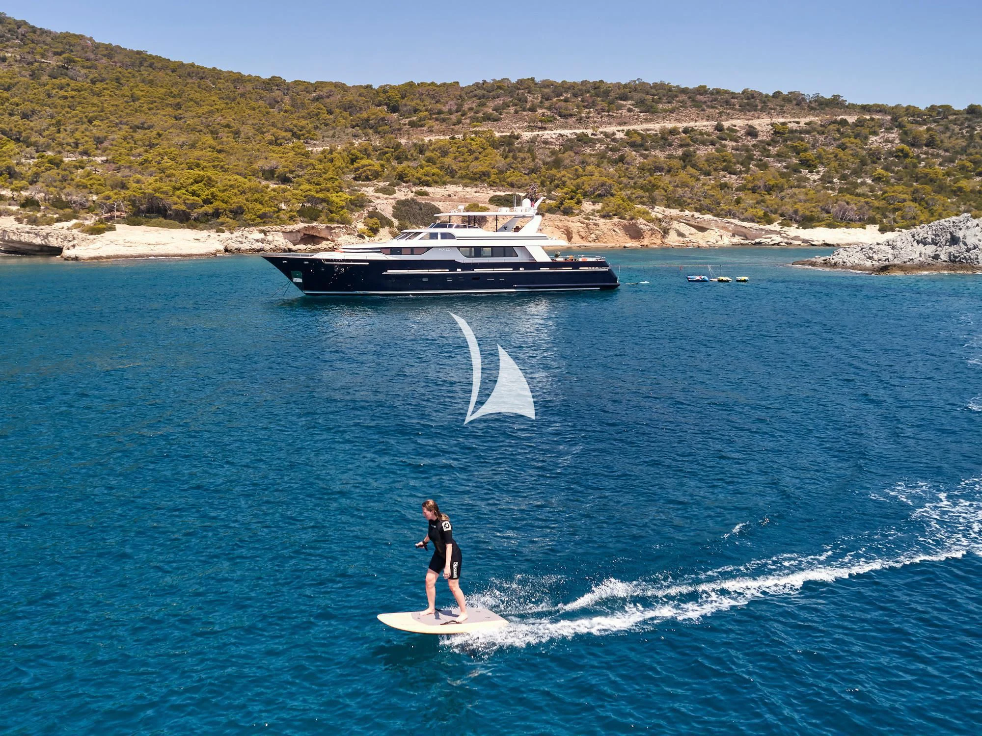 a person surfing on the sea aboard MIA ZOI Yacht for Charter