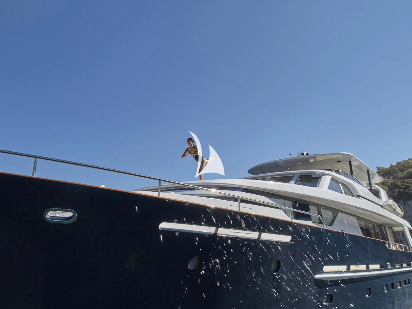 a person standing on a roof of a car aboard MIA ZOI Yacht for Charter