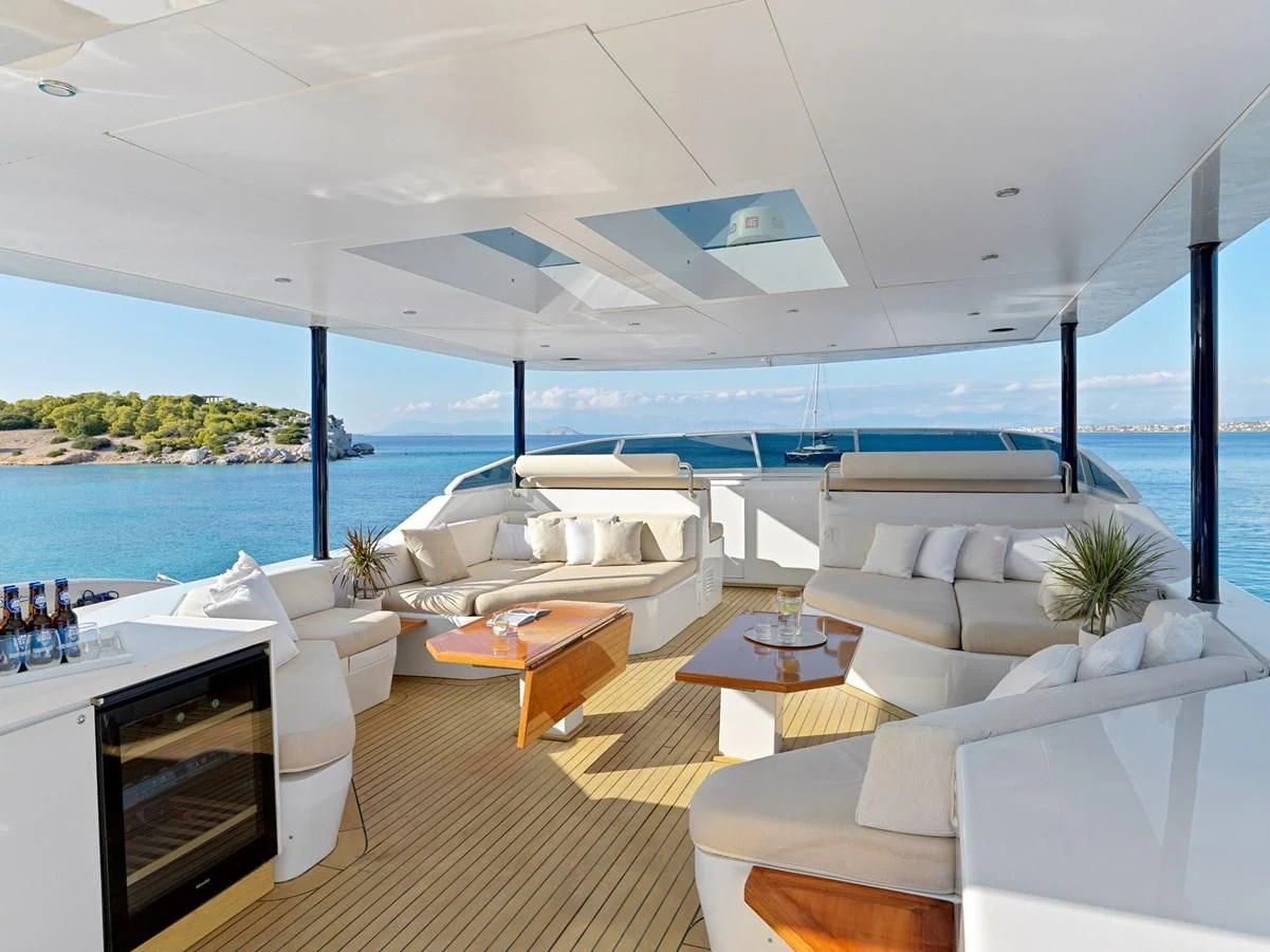 a room with a couch and a table and a large body of water aboard MIA ZOI Yacht for Charter