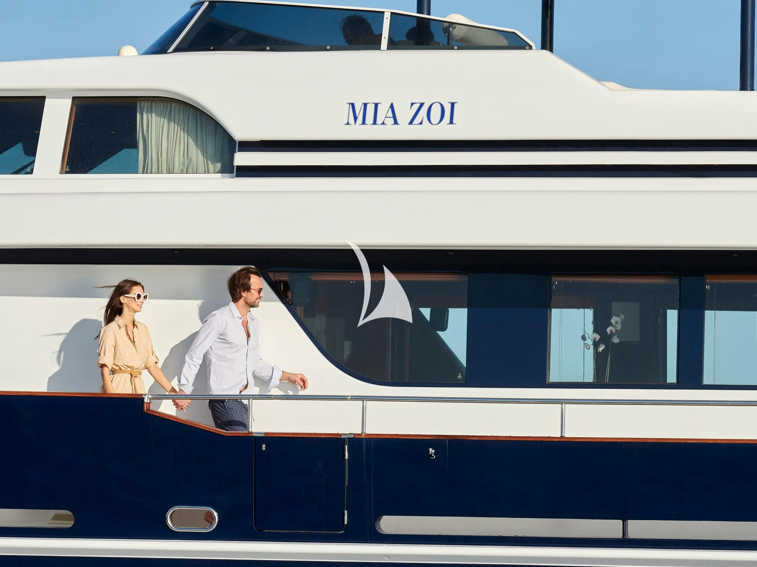 a group of people sitting on a train aboard MIA ZOI Yacht for Charter