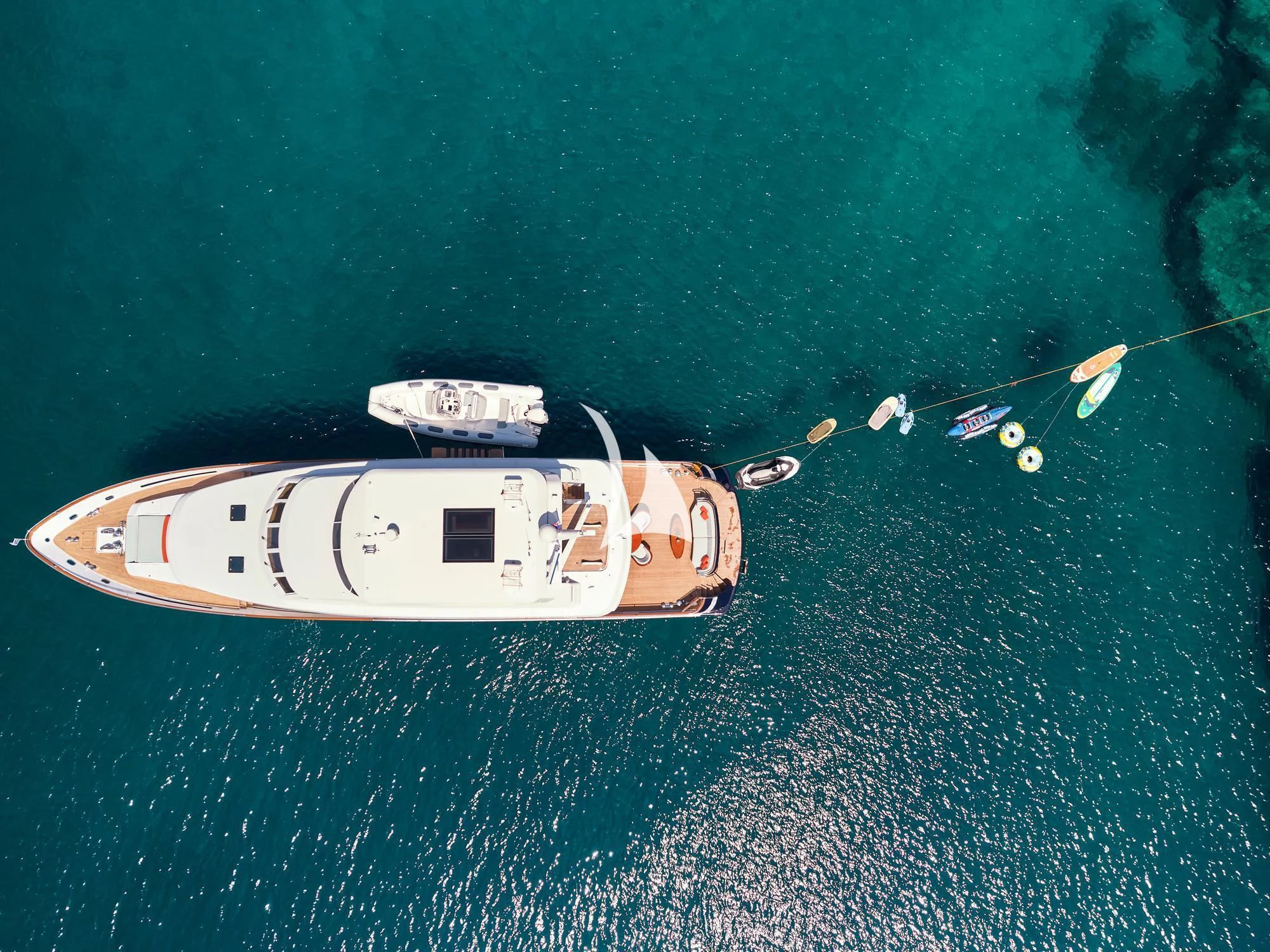 a helicopter flying over water aboard MIA ZOI Yacht for Charter