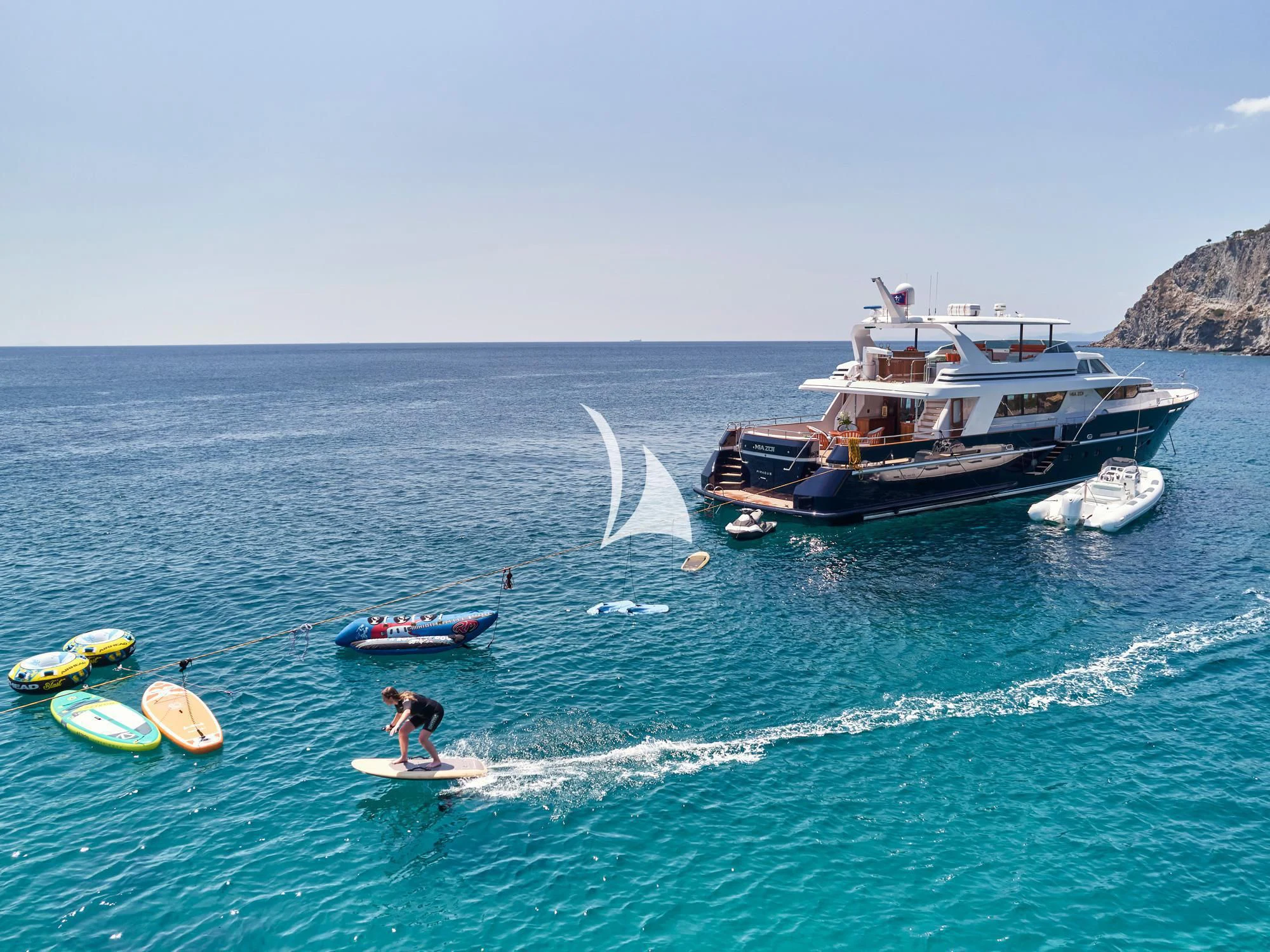 a person surfing on the sea aboard MIA ZOI Yacht for Charter