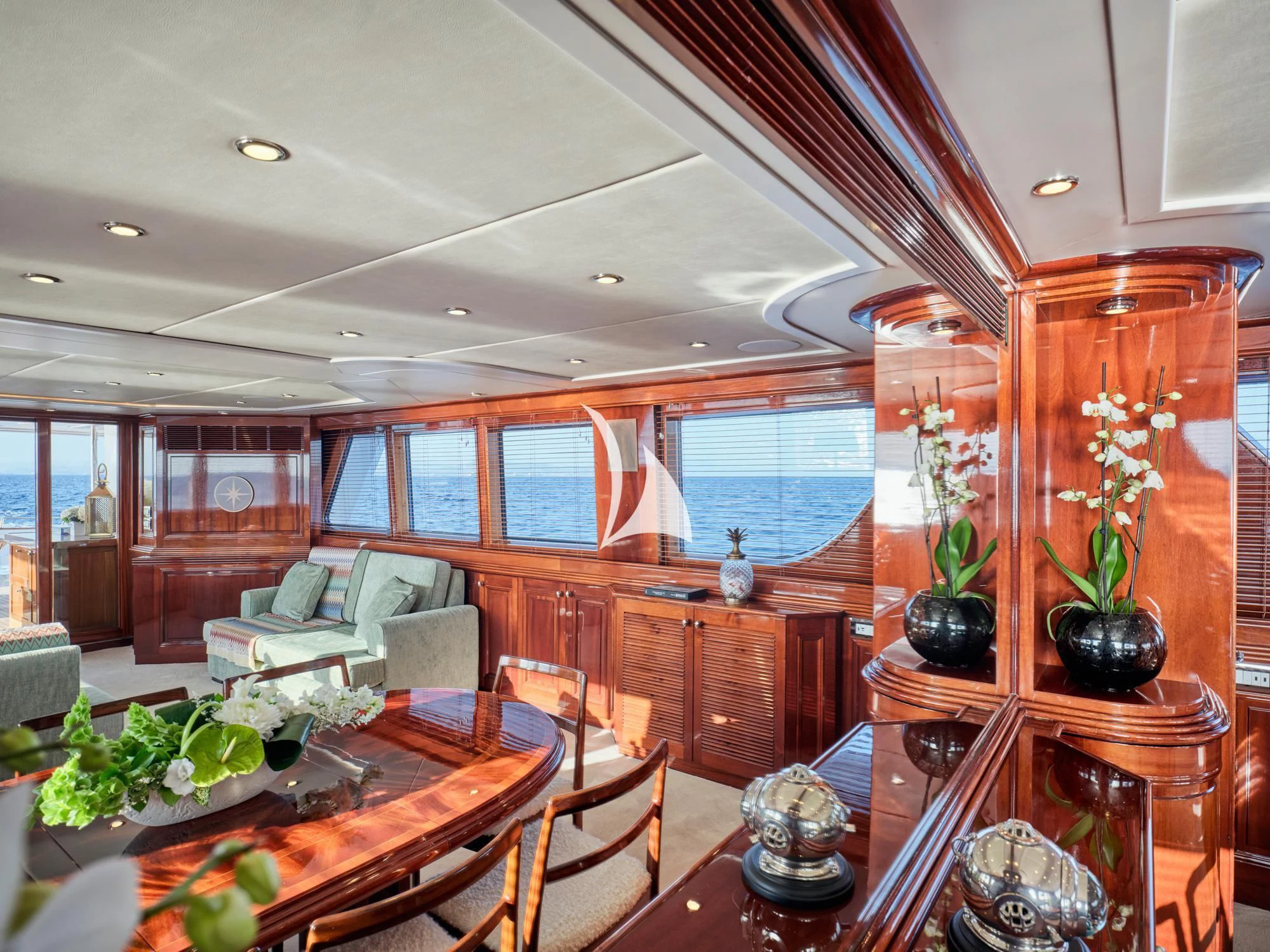 a living room with a large wood shelf and a large window aboard MIA ZOI Yacht for Charter