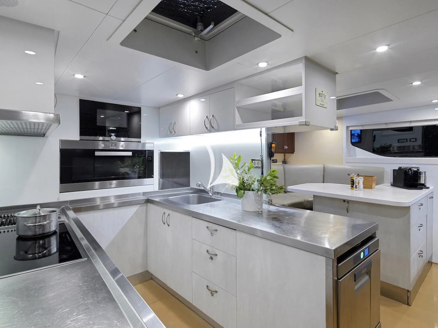 a kitchen with white cabinets aboard MIA ZOI Yacht for Charter