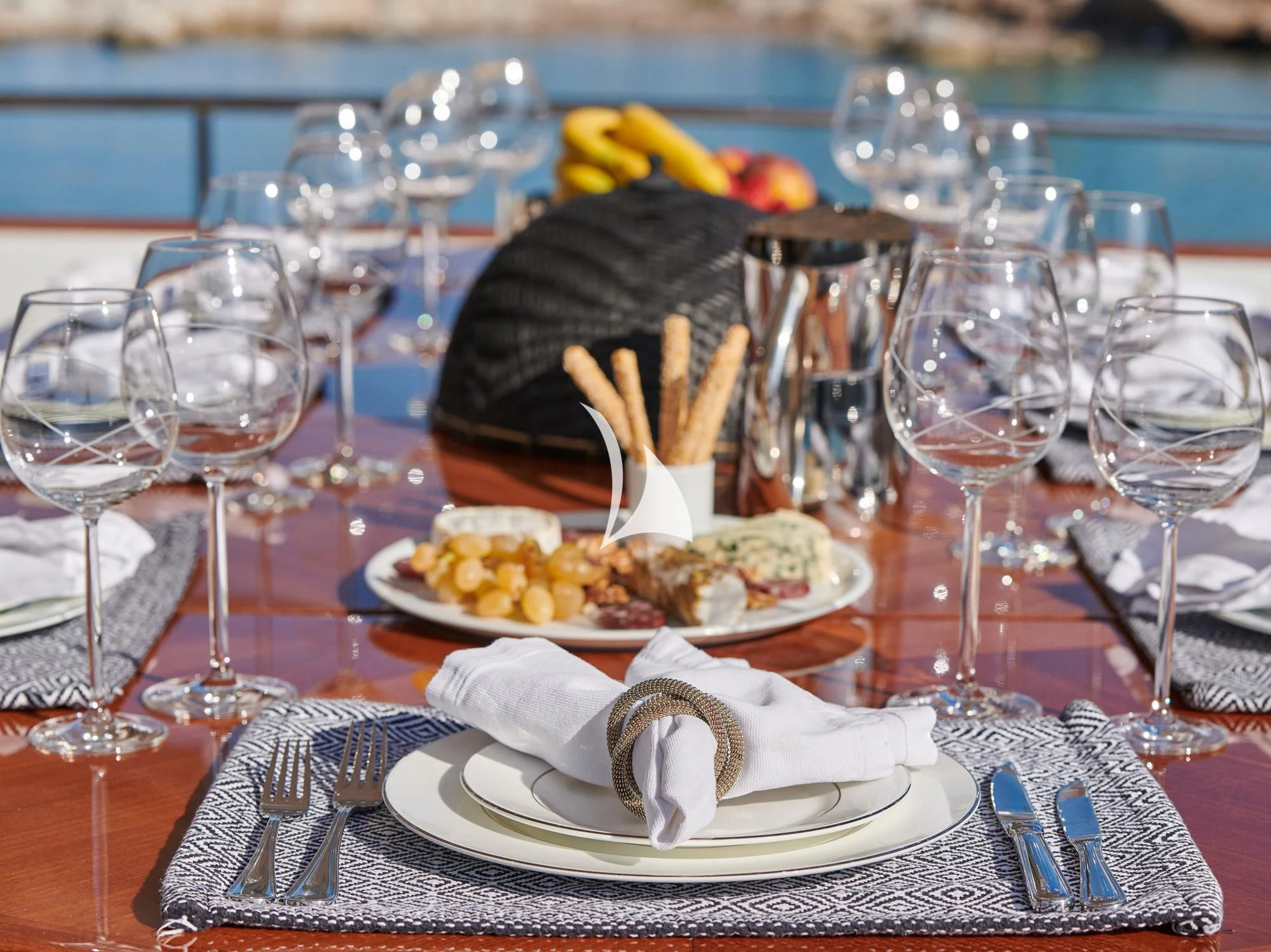 a table with plates of food and glasses of wine aboard MIA ZOI Yacht for Charter