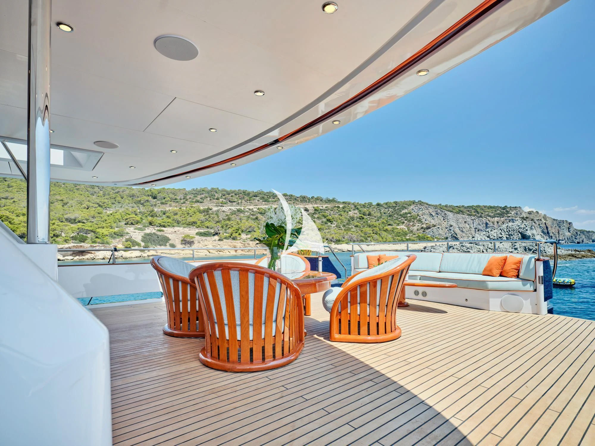 a table and chairs on a deck aboard MIA ZOI Yacht for Charter