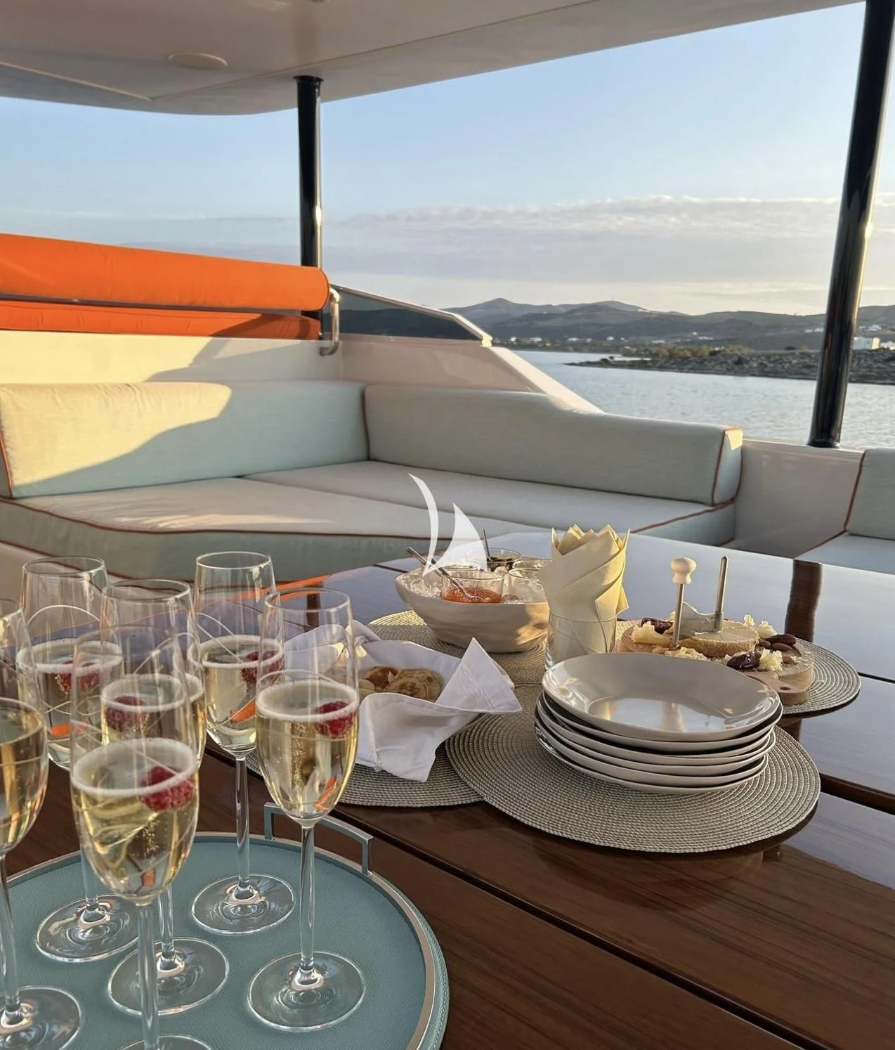 a table with plates and glasses on it aboard MIA ZOI Yacht for Charter