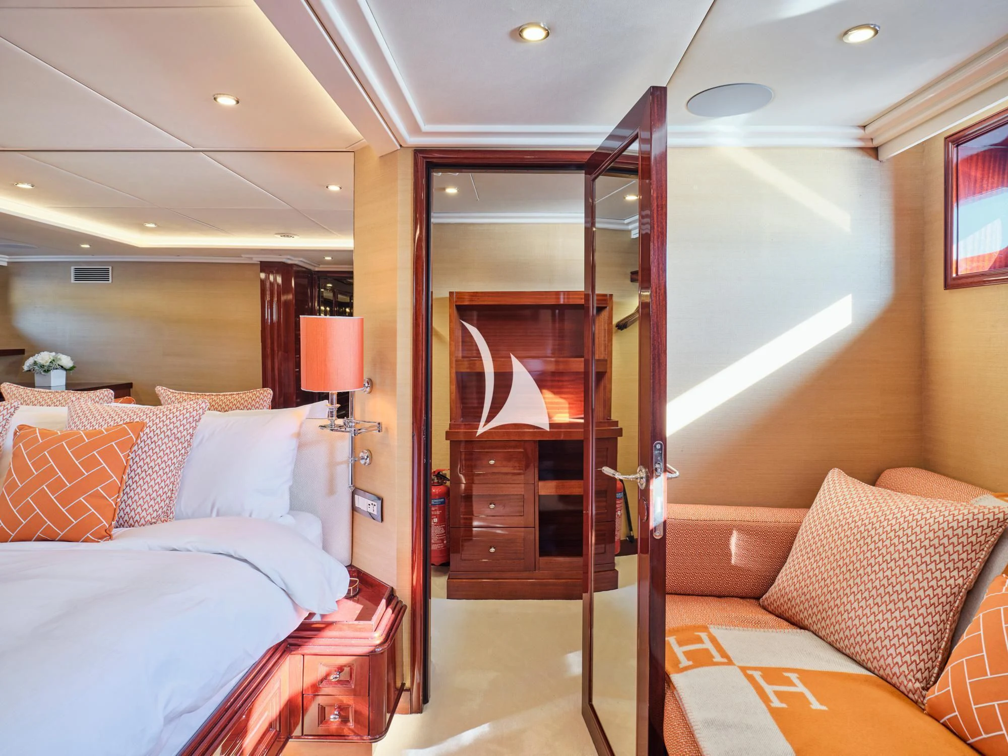 a room with a bed and a mirror aboard MIA ZOI Yacht for Charter