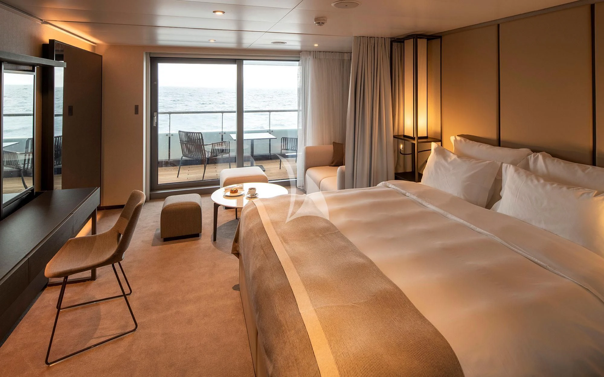 a hotel room with a bed and a desk aboard SCENIC ECLIPSE Yacht for Sale