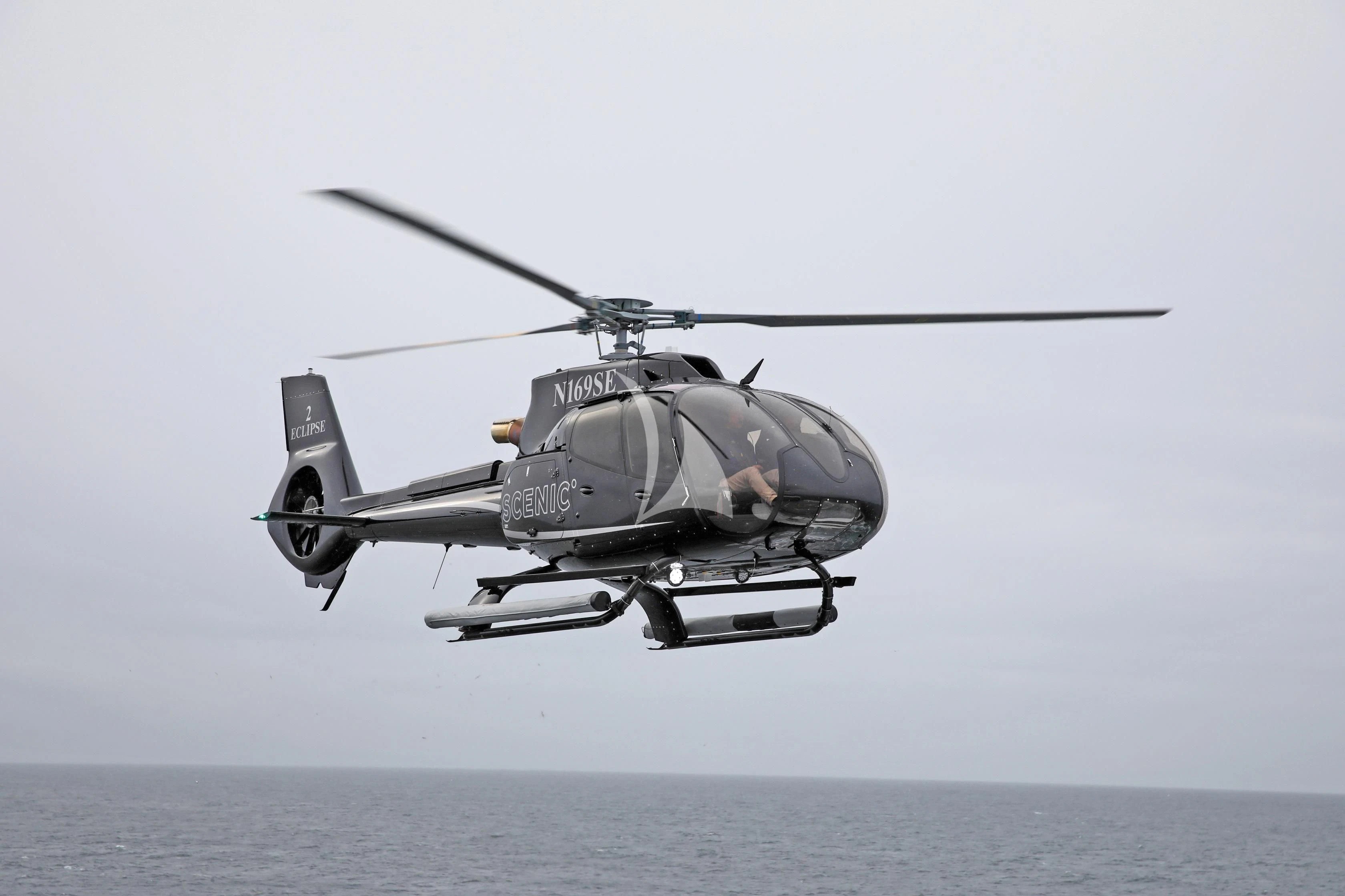 a helicopter flying over water aboard SCENIC ECLIPSE Yacht for Sale