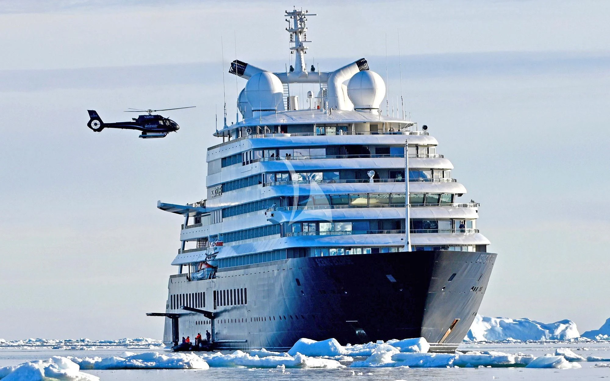 a helicopter flying over a large ship aboard SCENIC ECLIPSE Yacht for Sale