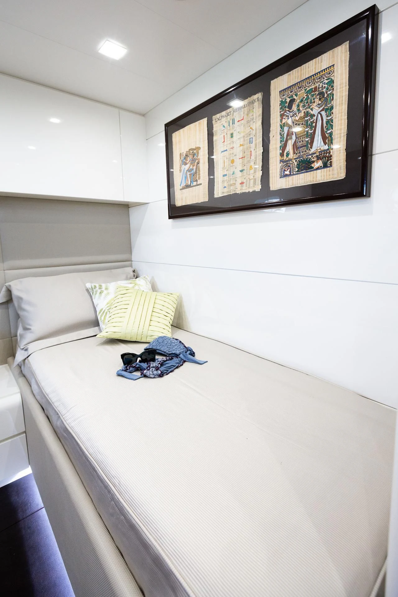 a bed with a blue blanket and pillows on it aboard CAMILLA A Yacht for Sale