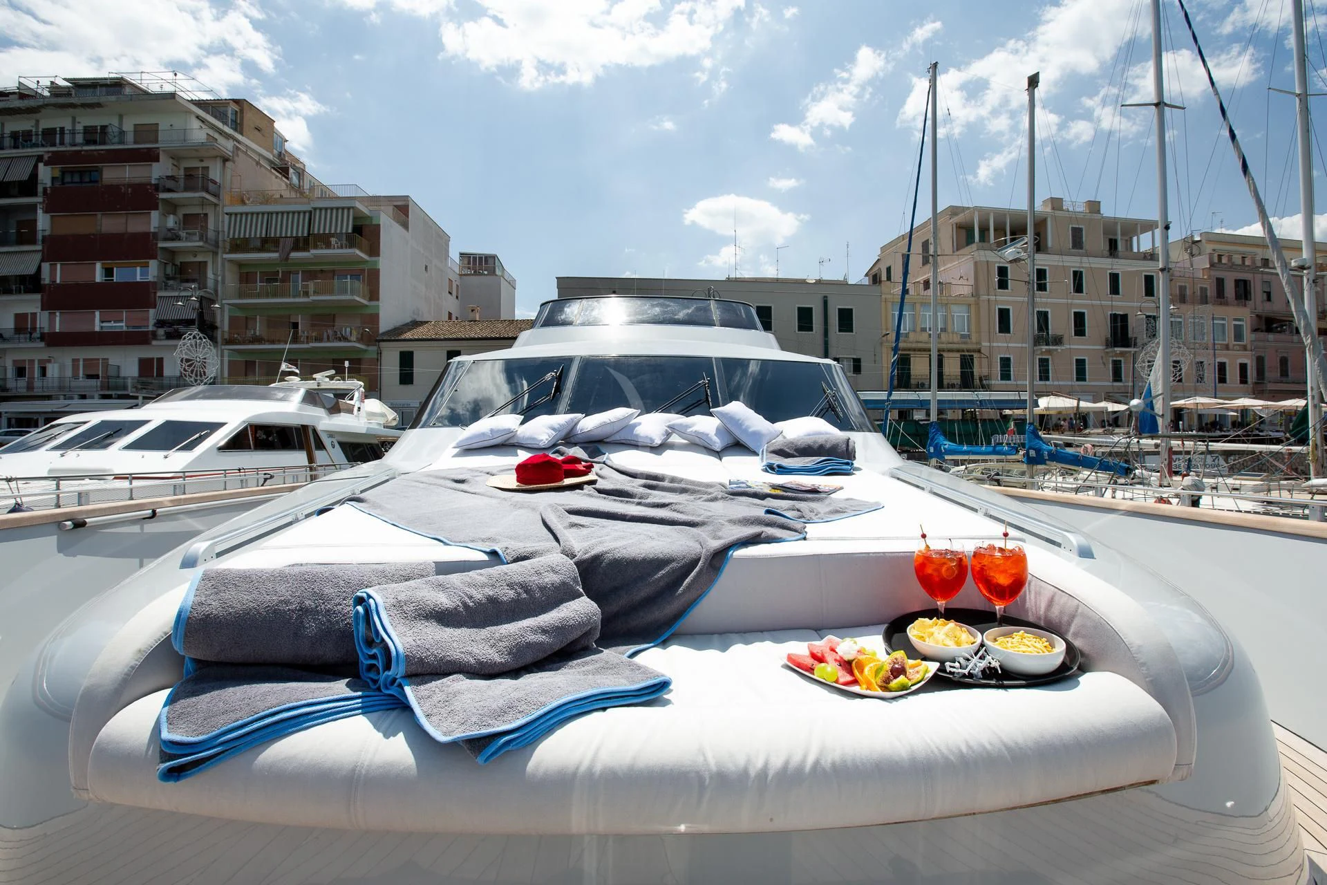 a white boat with a white cover on it aboard CAMILLA A Yacht for Sale