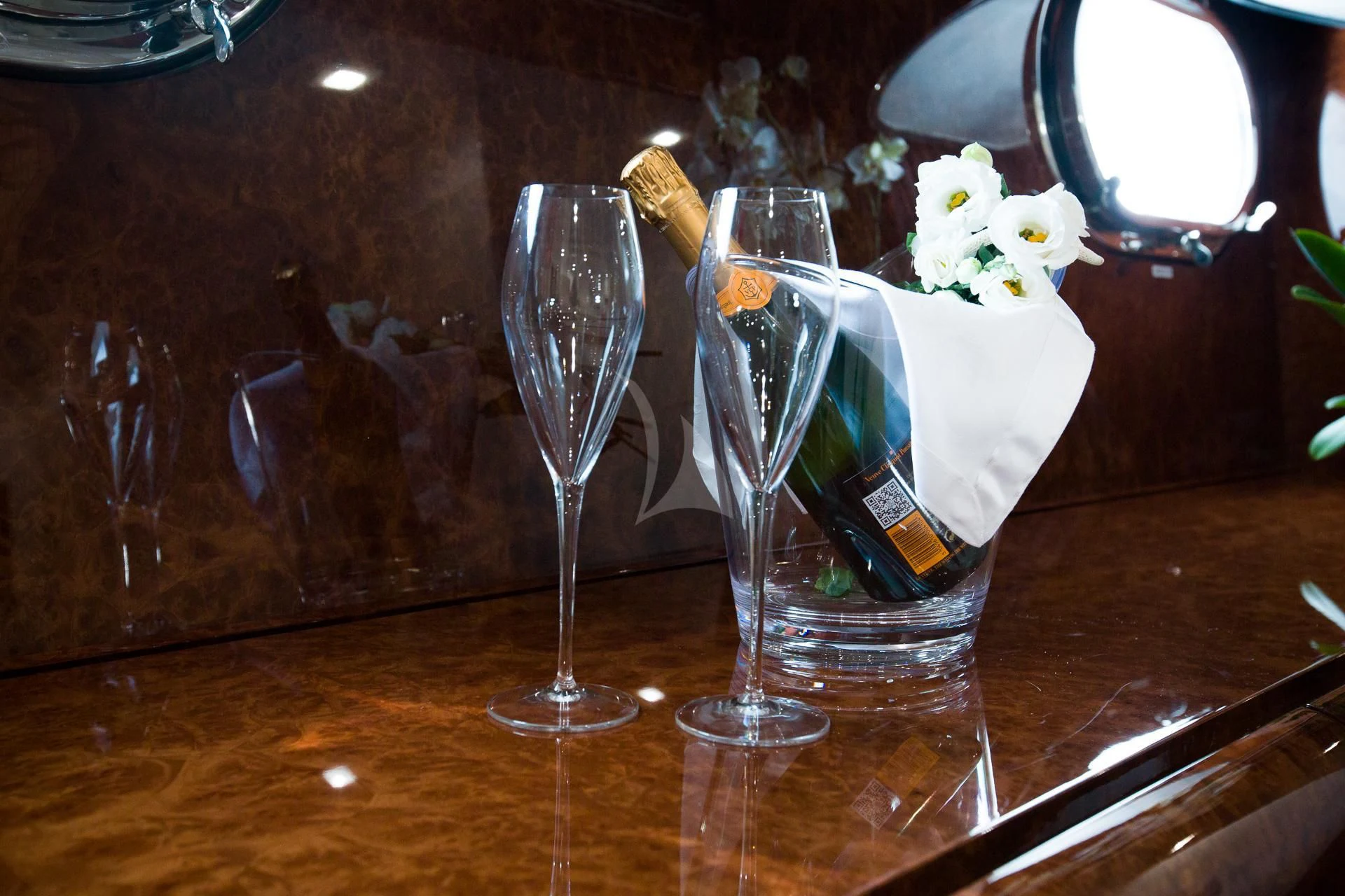 a glass of champagne on a table aboard CAMILLA A Yacht for Sale
