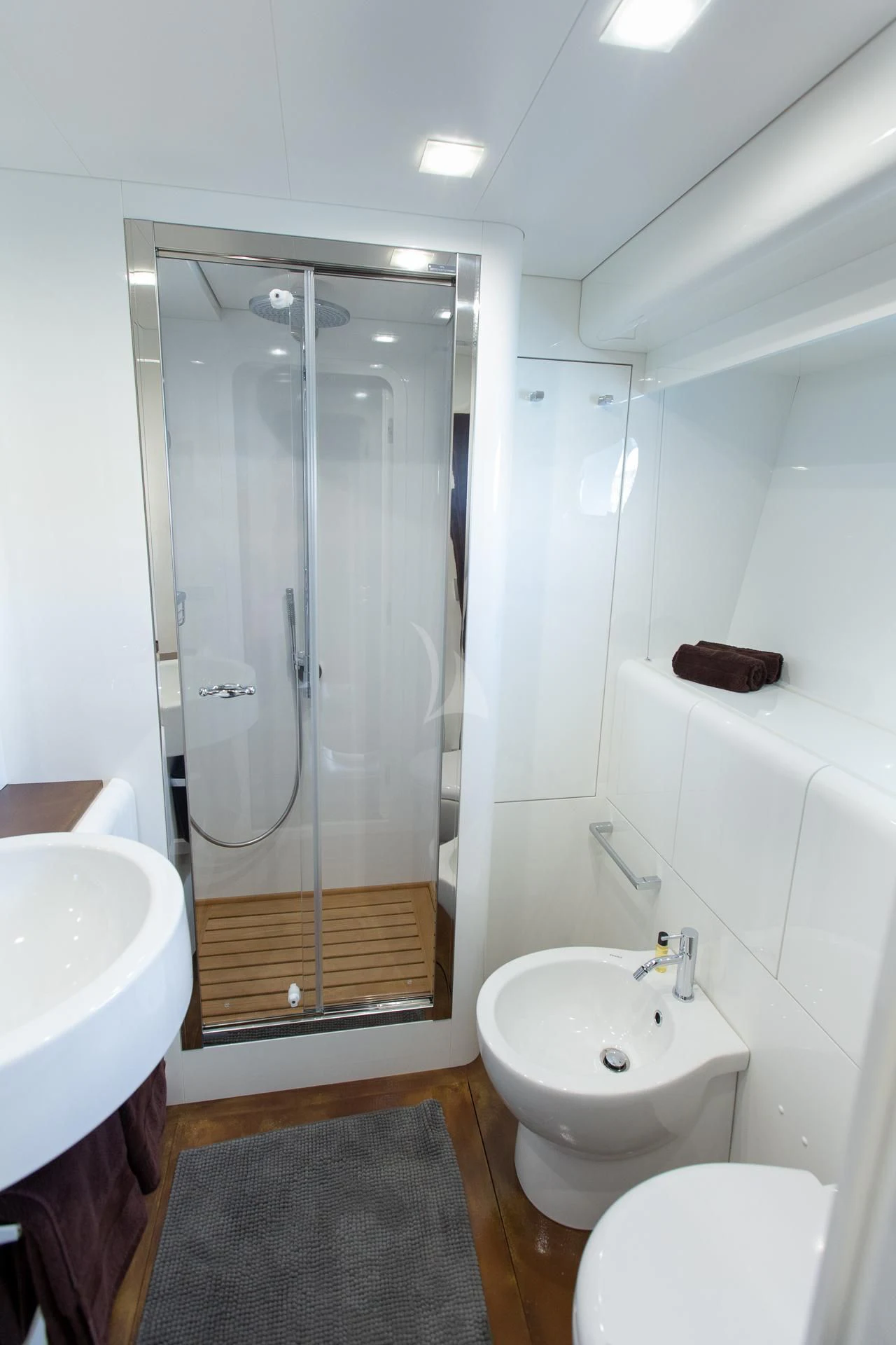 a bathroom with a glass shower aboard CAMILLA A Yacht for Sale