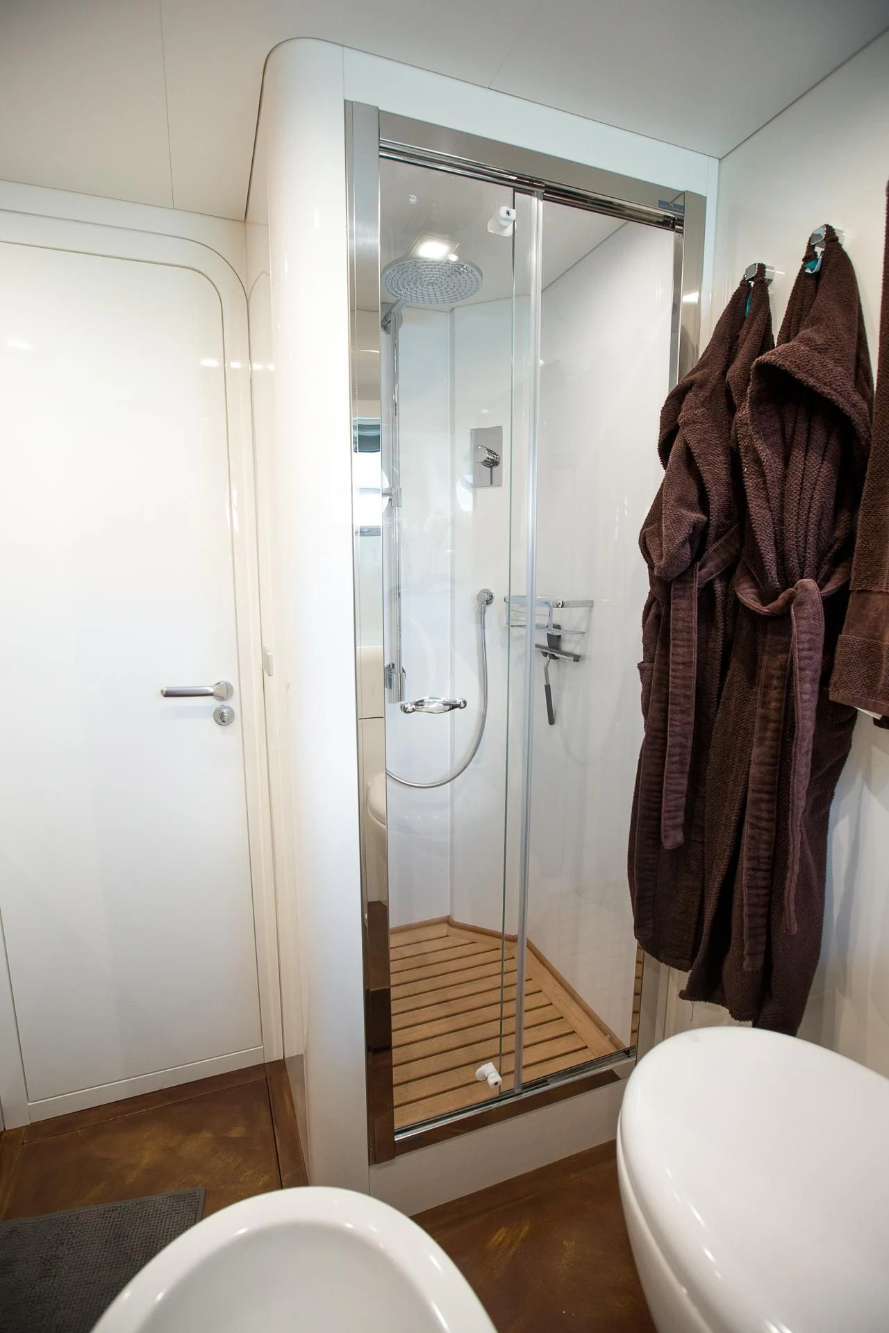 a bathroom with a glass shower door aboard CAMILLA A Yacht for Sale
