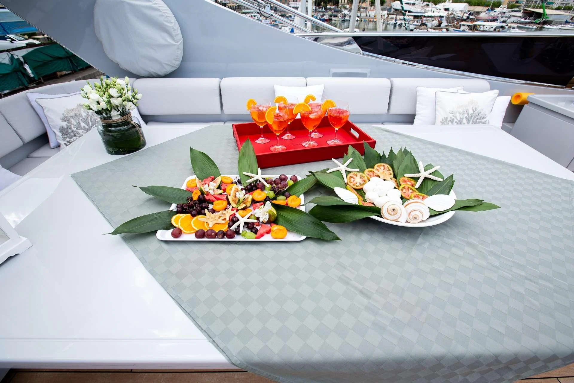 a table with flowers and plates aboard CAMILLA A Yacht for Sale