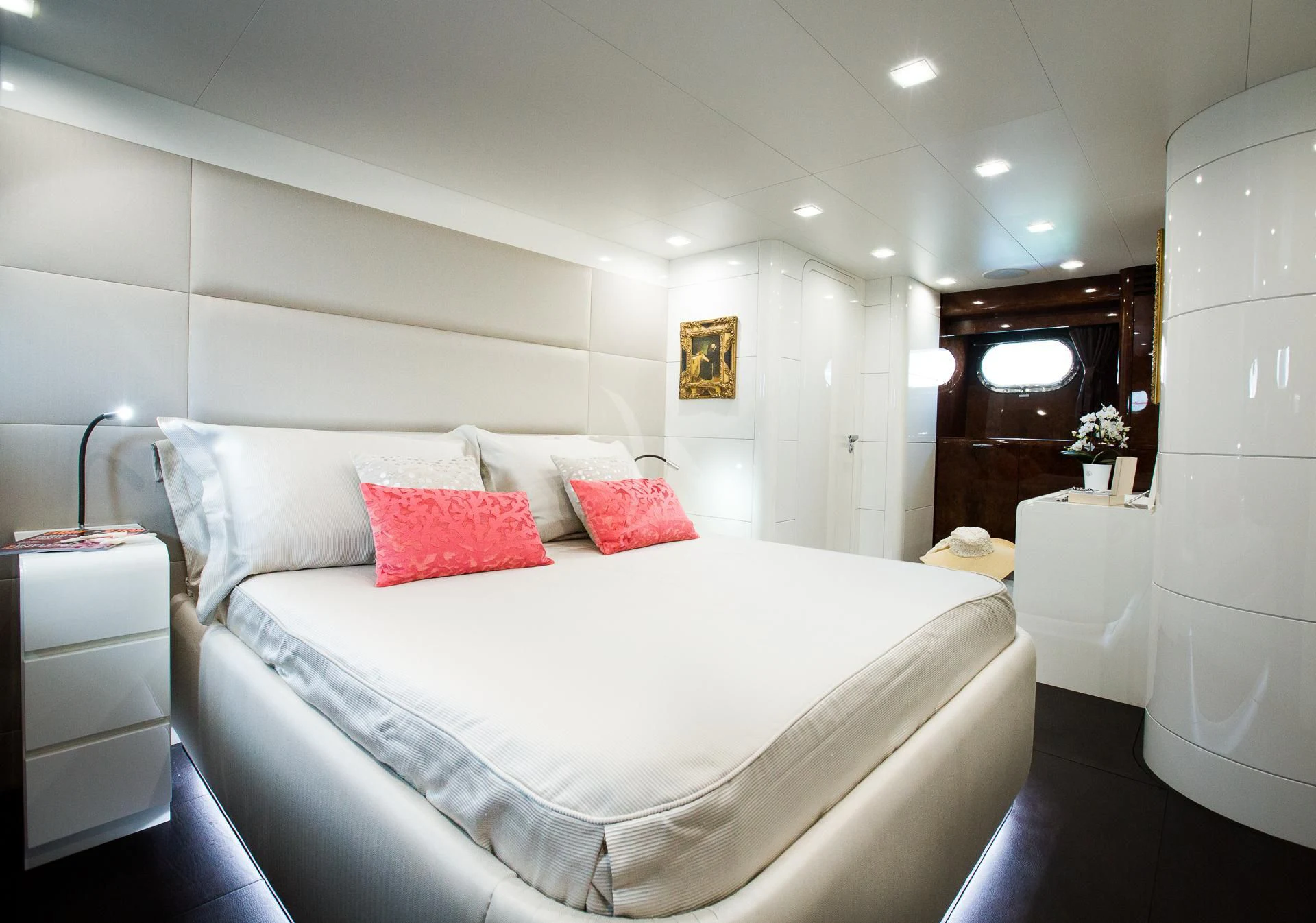 a bed with red pillows aboard CAMILLA A Yacht for Sale